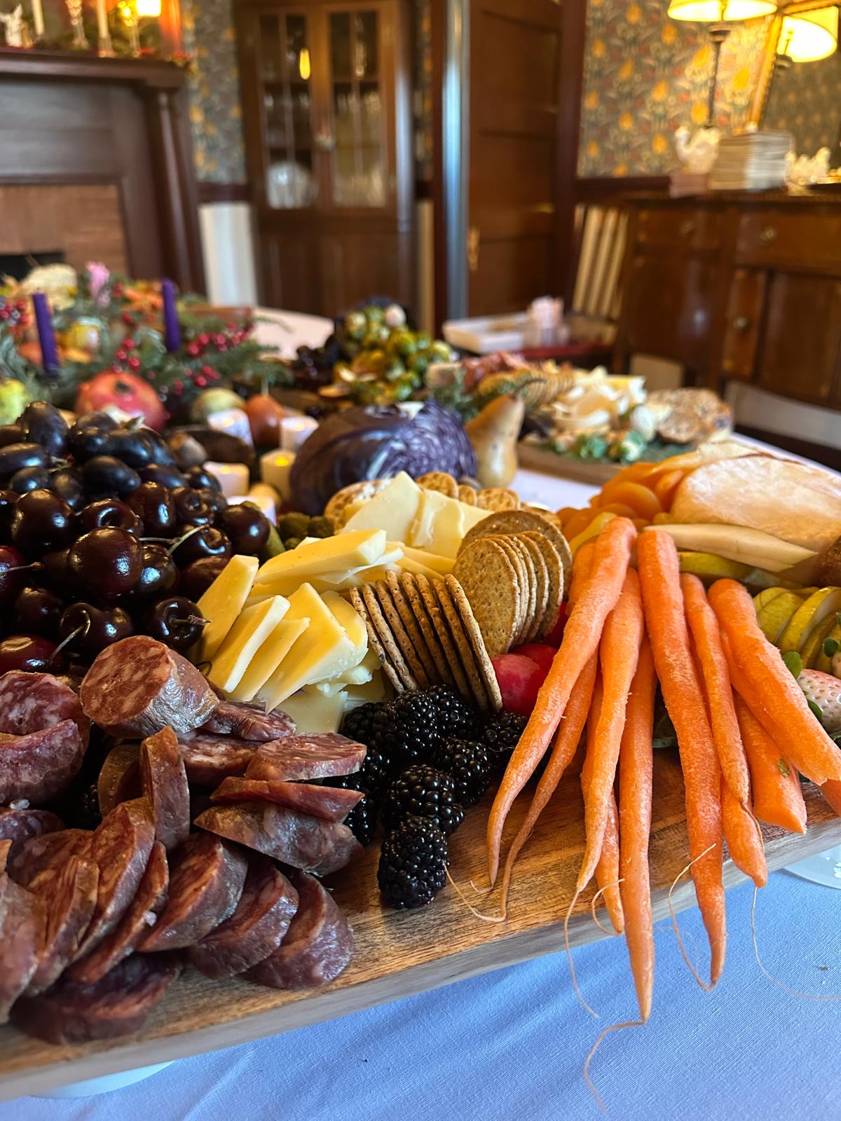 Seasonal salad, ripe fruit, fresh bread, and butter arranged for grazing