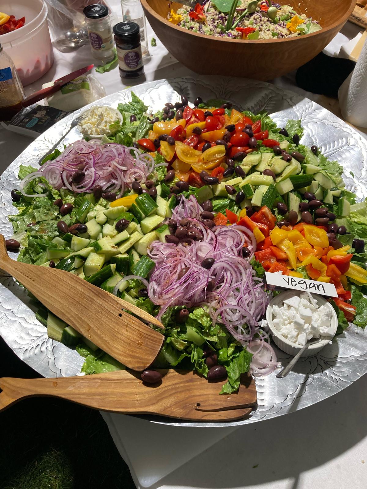 Vibrant chopped salad platter with heirloom tomatoes, cucumber, and sliced red onions